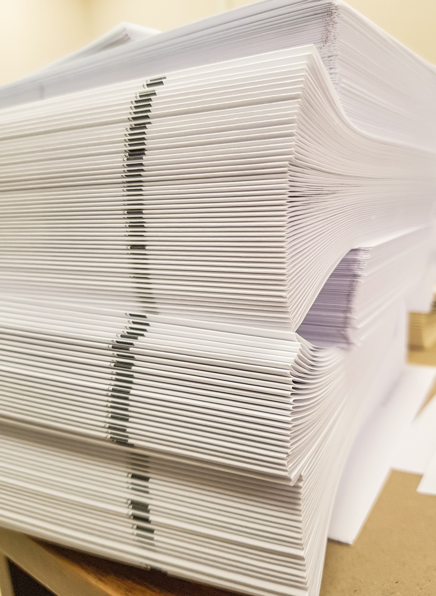A stack of blank paper, book blocks prepared for binding in a printing house